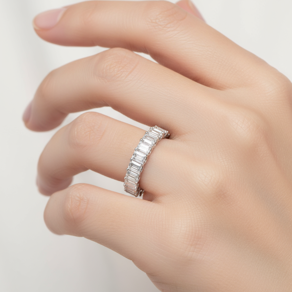 Female model wearing emerald-cut diamond half-eternity band ring