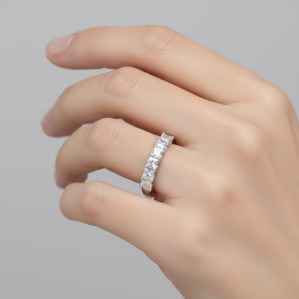 Female model wearing princess-cut diamond half-eternity band ring