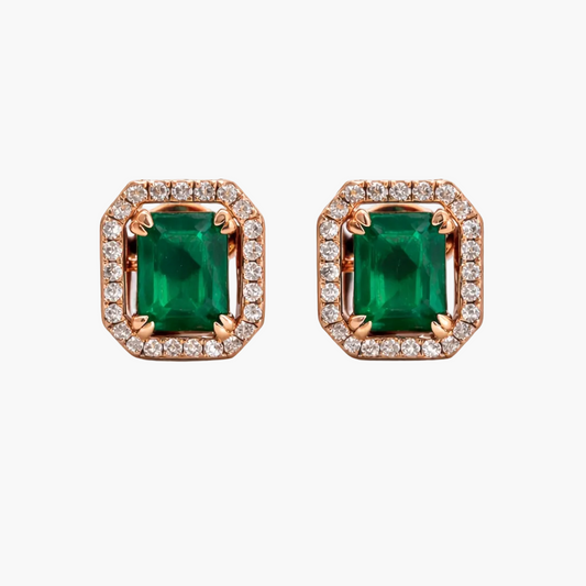 Pair of emerald green gemstone earrings with rose gold and diamond accents on a white background