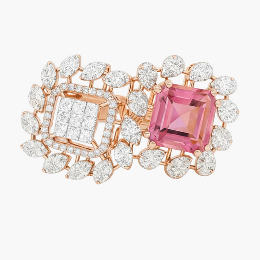 Ornate brooch with pink gemstone and diamonds on a white background