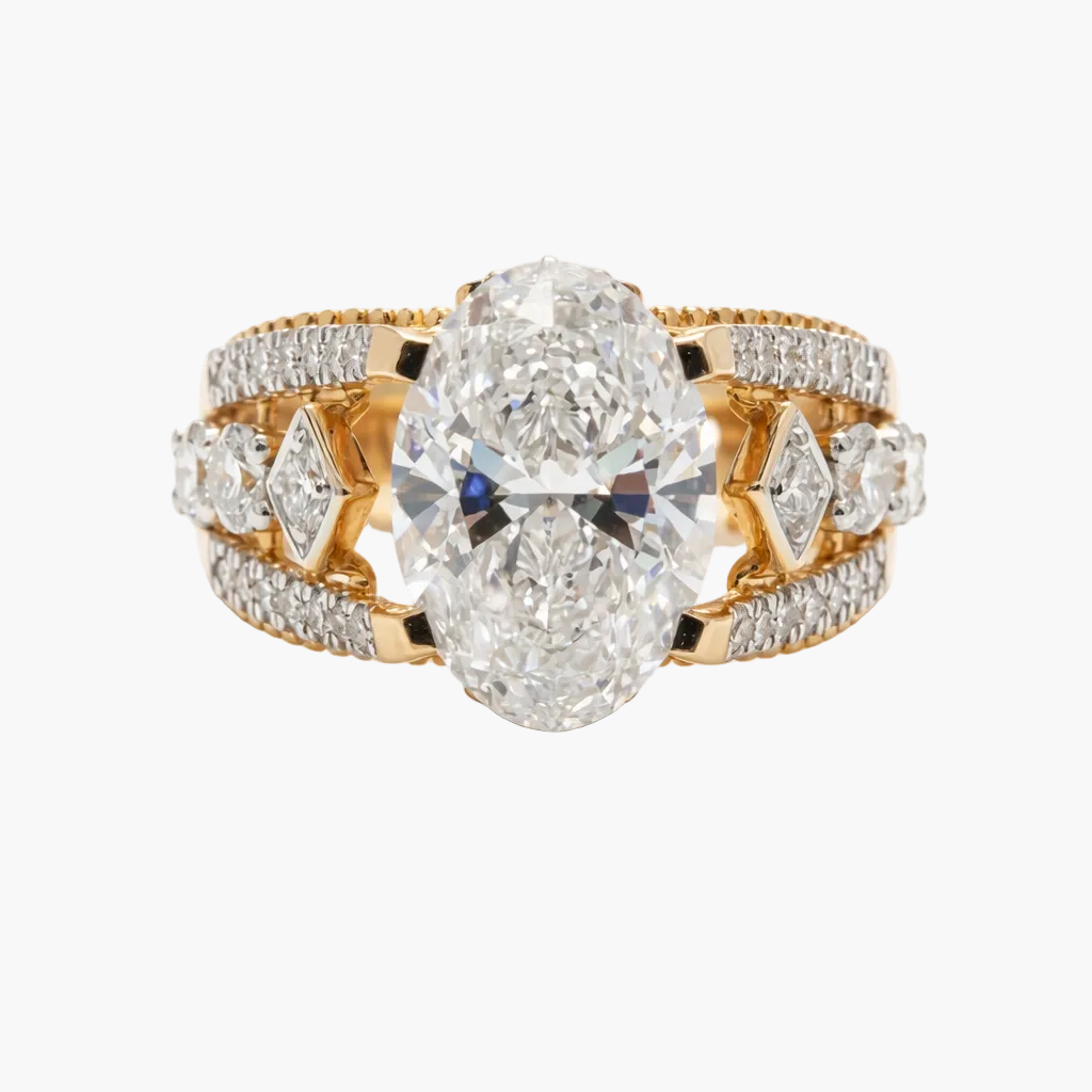 Gold ring with two large pear-shaped diamonds and smaller diamonds on a white background
