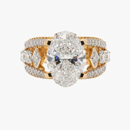 Gold ring with two large pear-shaped diamonds and smaller diamonds on a white background