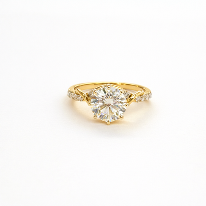 Gold ring with a large diamond on a white background