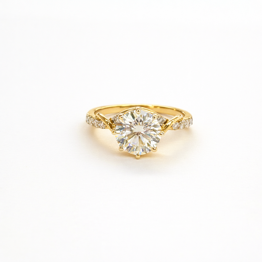 Gold ring with a large diamond on a white background