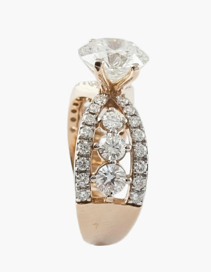 Rose gold ring with diamond accents on a light gray background