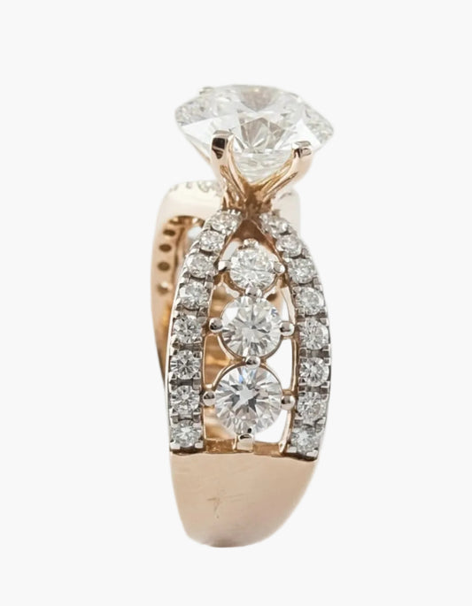 Rose gold ring with diamond accents on a light gray background