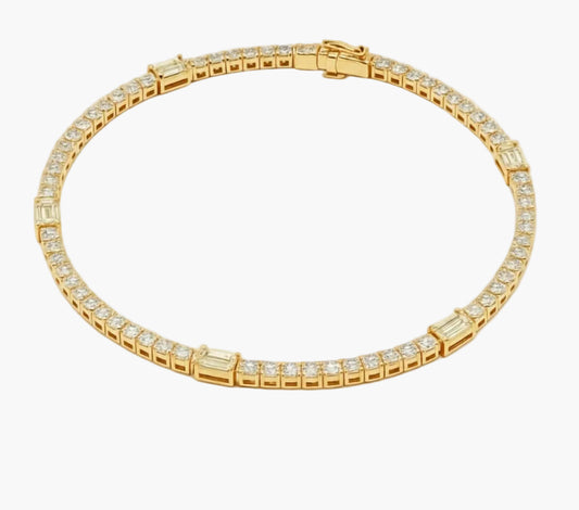 Gold bracelet with diamond accents on a white background