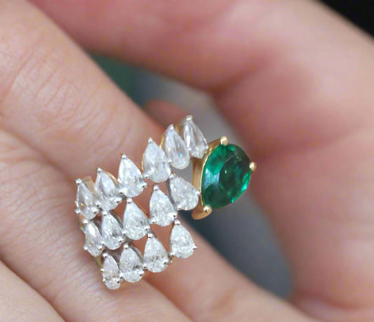 Ring with emerald and diamonds on a hand