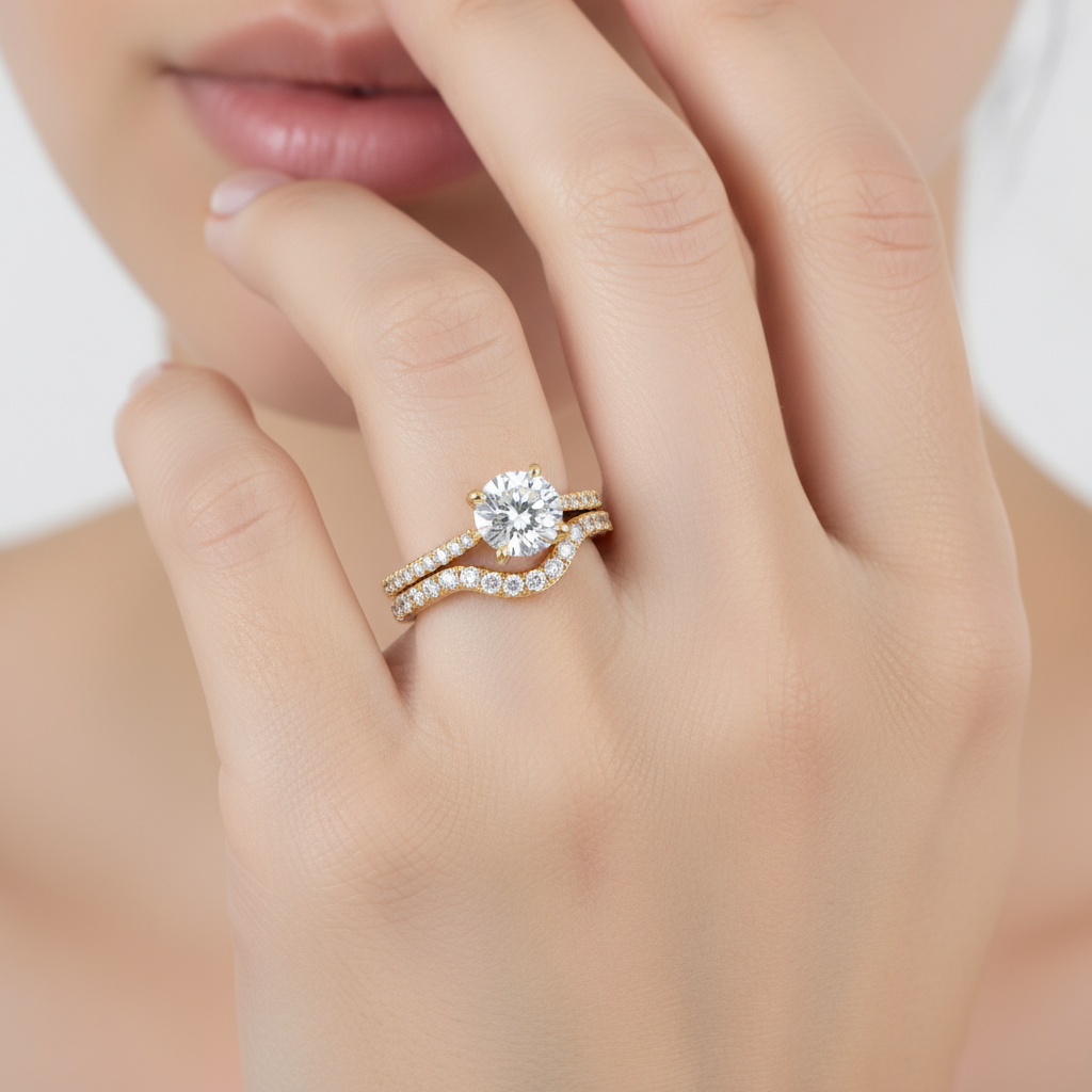 Female model wearing diamond engagement ring set with curved wedding band