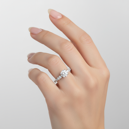 Female model wearing diamond engagement ring with graduated side stones
