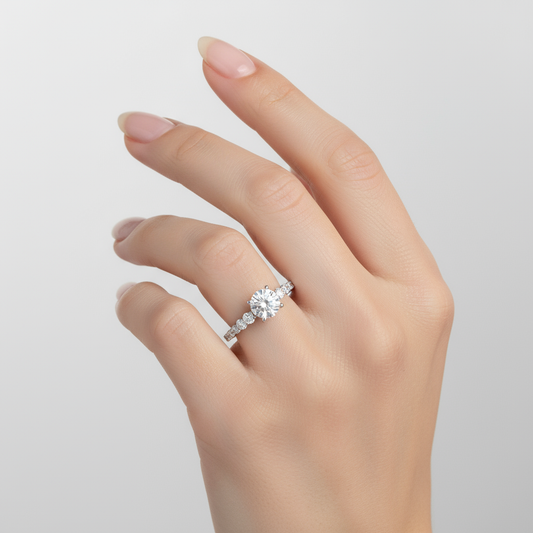 Female model wearing diamond engagement ring with graduated side stones