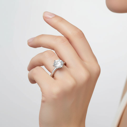 Female model wearing diamond solitaire engagement ring