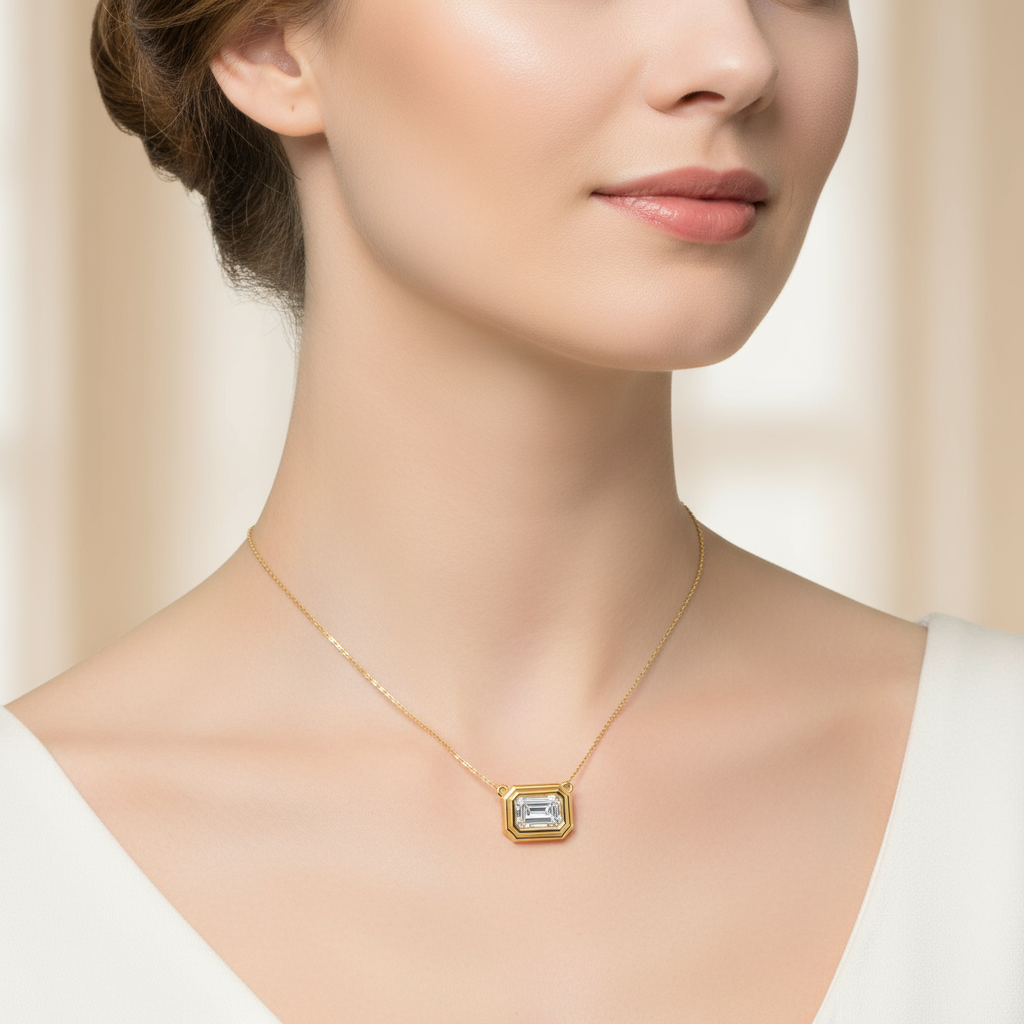 Female model wearing emerald-cut diamond bezel pendant