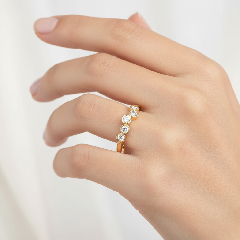 Female model wearing five-stone bezel-set diamond band ring