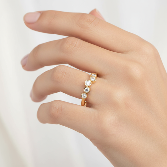 Female model wearing five-stone bezel-set diamond band ring
