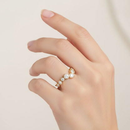 Female model wearing graduated mixed-shape diamond bezel-set band ring