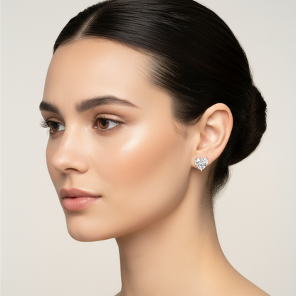 Female model wearing heart-shaped diamond solitaire stud earrings
