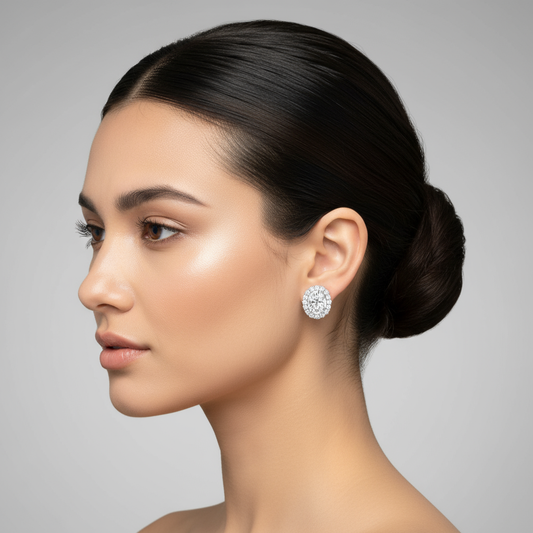 Female model wearing oval diamond halo stud earrings