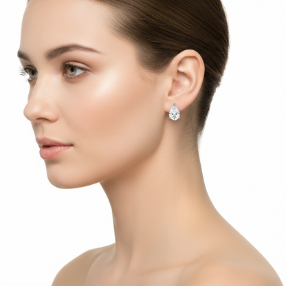 Female model wearing pear diamond earrings