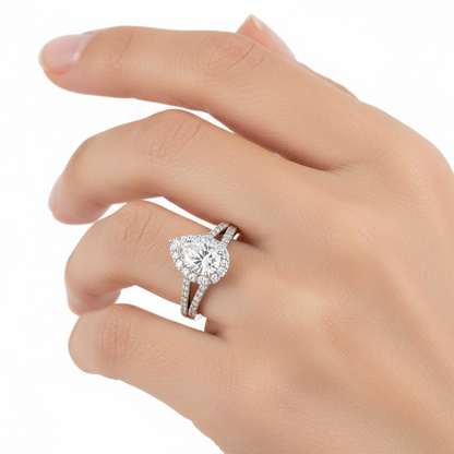 Female model wearing pear diamond halo ring