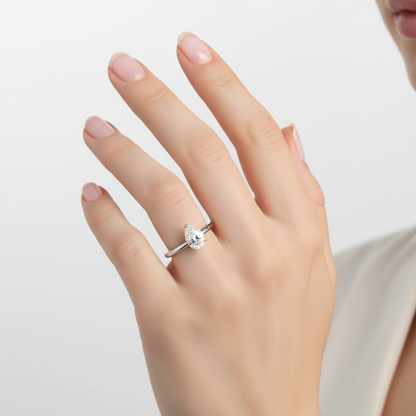 Female model wearing pear-shaped diamond solitaire engagement ring