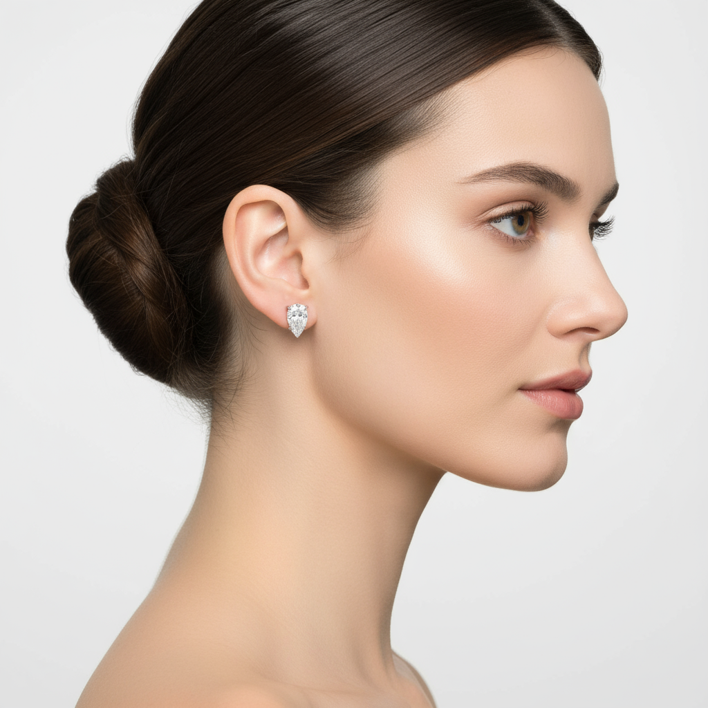 Female model wearing pear-shaped diamond stud earrings