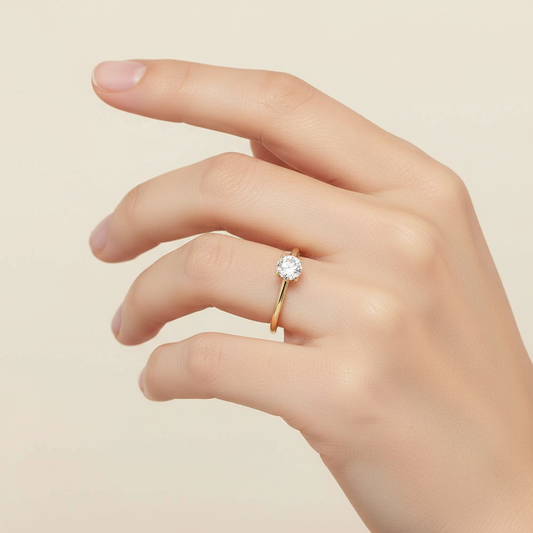 Female model wearing round diamond solitaire engagement ring