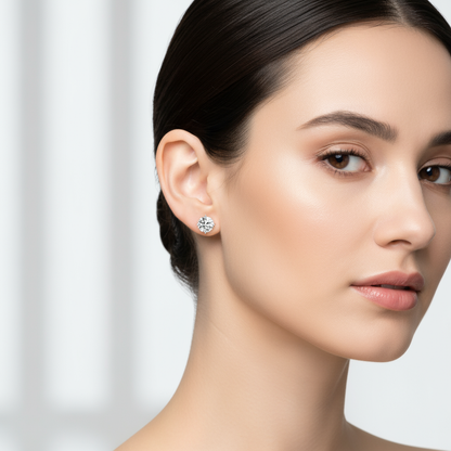 Female model wearing round diamond solitaire stud earrings
