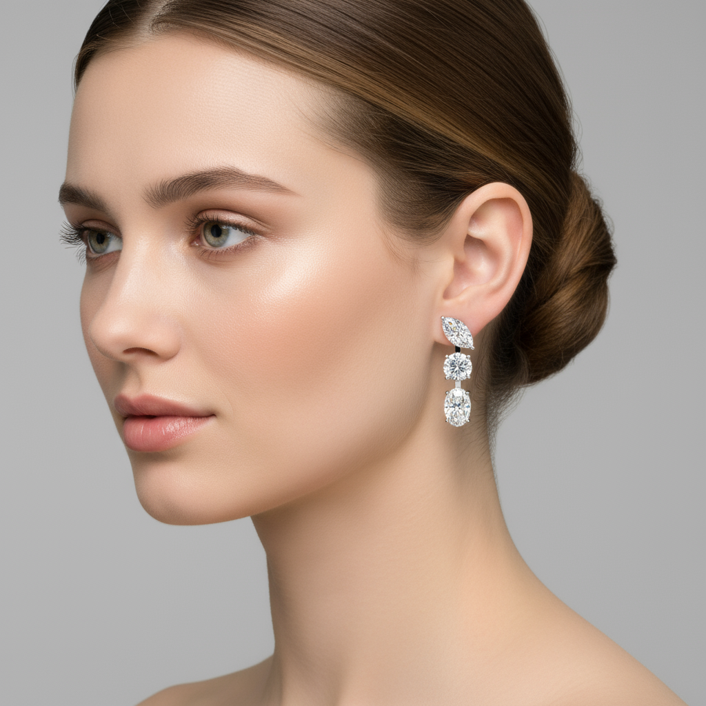 Female model wearing three-stone diamond drop earrings