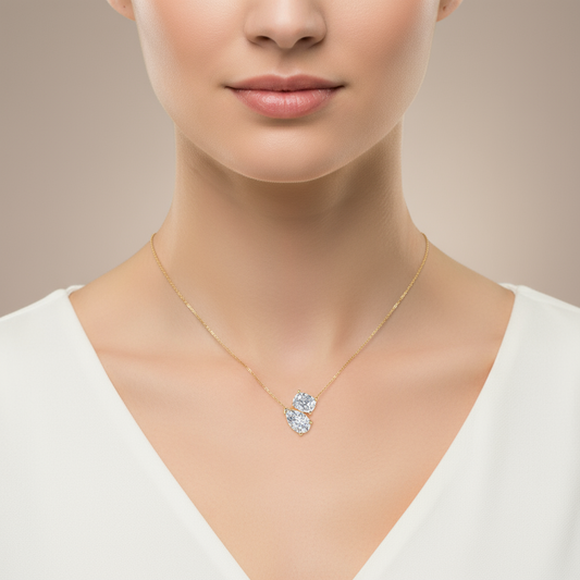 Female model wearing two-stone diamond pendant