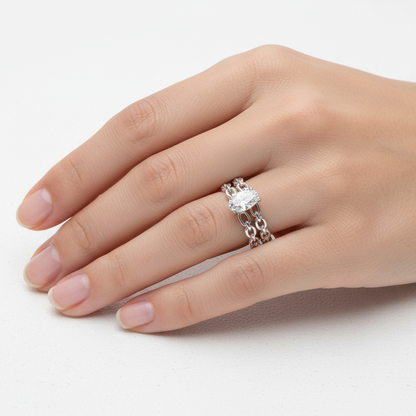 Generated image of a female model wearing small-sized white gold chain-link ring with pear-shaped diamond