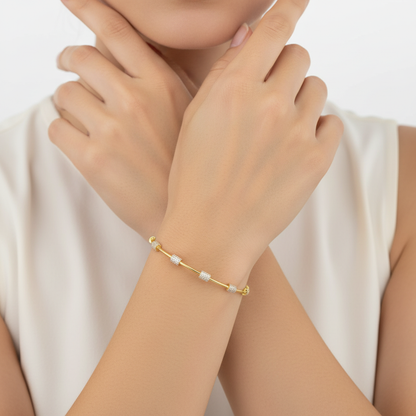 Generated image of a female model wearing small-sized yellow gold bangle bracelet with pavé diamond stations