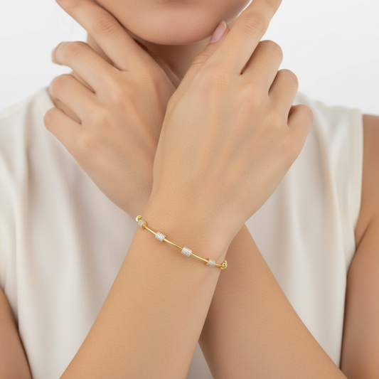 Generated image of a female model wearing small-sized yellow gold bangle bracelet with pavé diamond stations